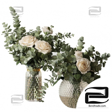 Bouquets Two bouquets of roses and eucalyptus branches in glass pimpled vases