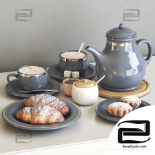 Tea set with croissants and cupcakes