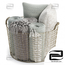 Metal basket with pillows and blankets